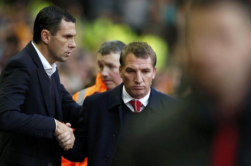 Sunderland manager Gus Poyet, left, greets Liverpool manager Brendan Rodgers on Saturday before their Premier League match. Phil Noble / Reuters