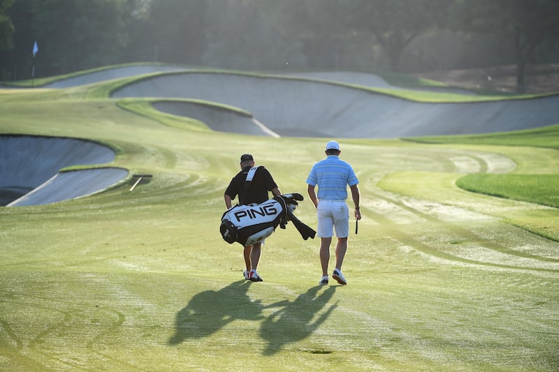 Lee Westwood of England walks with caddie Billy Foster. There are effectively two main prizes on offer this week: the DP World Tour Championship title and the Race to Dubai crown.  Ross Kinnaird / Getty Images