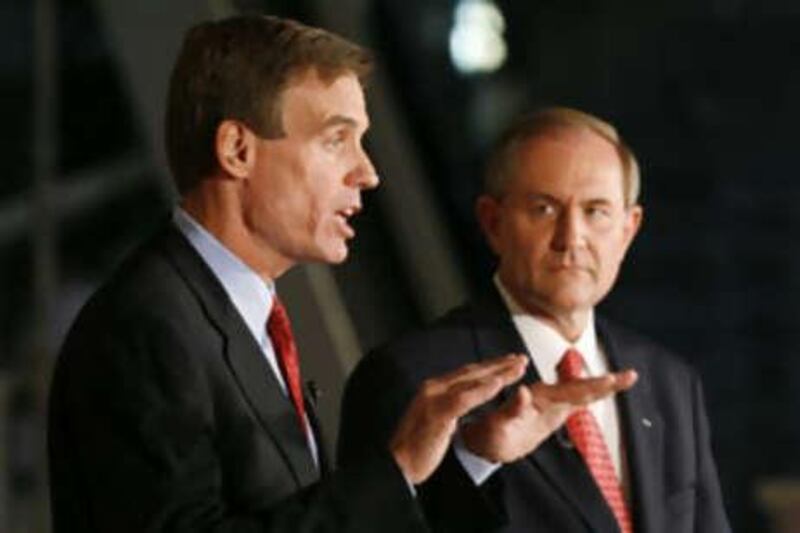 Mark Warner, a Democrat, left, gestures as Jim Gilmore, a Republican, looks on at a debate in Virginia.