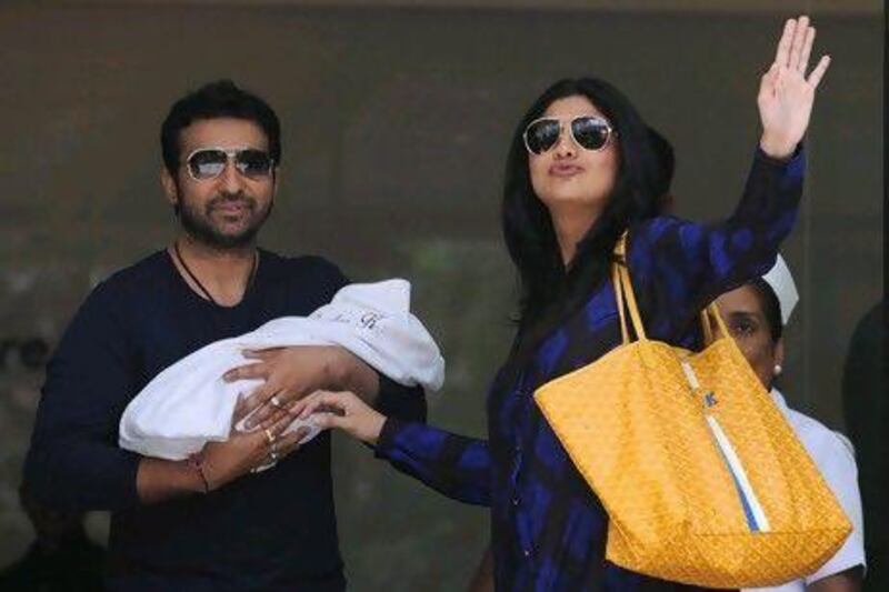 Raj Kundra, Shilpa Shetty and their baby. Indranil Mukherjee / AFP