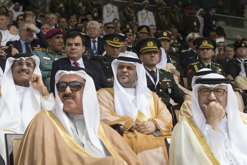 Abdul Rahman Mohammed Al Owais, right, the Minister of Health and Prevention, and Saqr Ghobash Saeed Ghobash, the Minister of Human Resources and Emiratisation, watch the opening ceremony of the 2017 International Defence Exhibition and Conference. Philip Cheung / Crown Prince Court - Abu Dhabi
