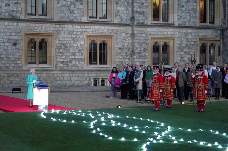 Britain's Queen Elizabeth leads the lighting of the principal jubilee beacon, as part of platinum jubilee celebrations, at Windsor Castle, Britain June 2, 2022. Reuters