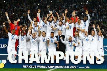 Soccer Football - FIFA Club World Cup - Final - Real Madrid v Al Hilal - Prince Moulay Abdellah Stadium, Rabat, Morocco - February 11, 2023  Real Madrid's Karim Benzema lifts the trophy with teammates and coach Carlo Ancelotti after winning the FIFA Club World Cup final REUTERS / Andrew Boyers