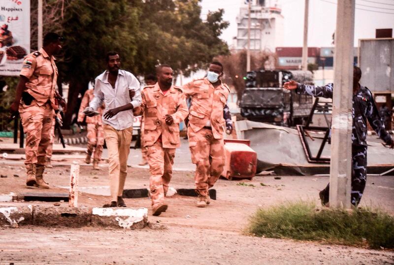 Troops detain a man in the Red Sea city of Port Sudan.  AFP