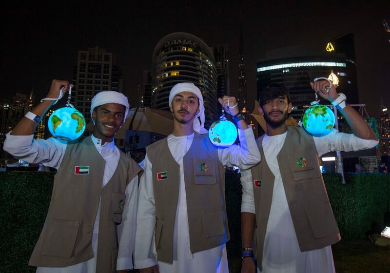 DUBAI, UNITED ARAB EMIRATES - Local boys with their earth lanterns during Earth Hour at the DEWA, Earth Hour at Mirasi Promenade, Dubai.  Leslie Pableo for The National