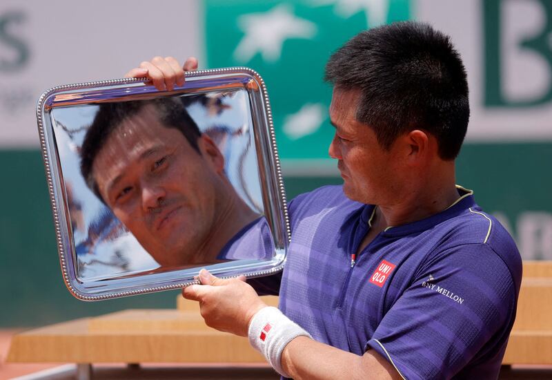 Japan's Shingo Kunieda celebrates with trophy after winning the men's wheelchair tennis final against Argentina's Gustavo Fernandez at the French Open in Paris. Reuters