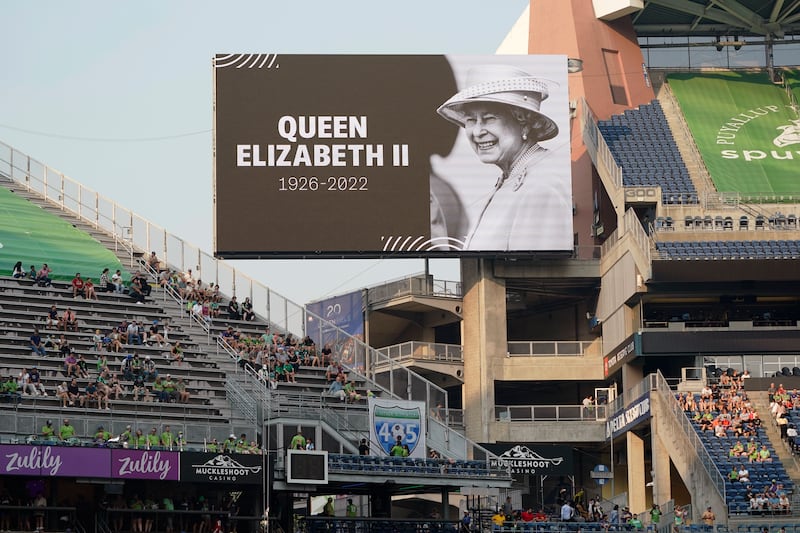 A photo of Queen Elizabeth is displayed before an MLS soccer match between the Seattle Sounders and Austin FC at Lumen Field in Seattle, Washington. AP