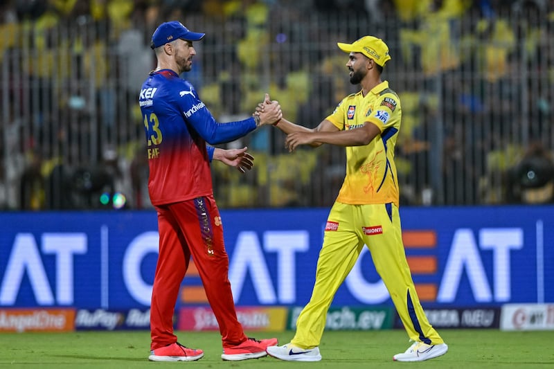 Chennai Super Kings' captain Ruturaj Gaikwad shakes hands with his Royal Challengers Bangalore's counterpart Faf du Plessis after the game. AFP
