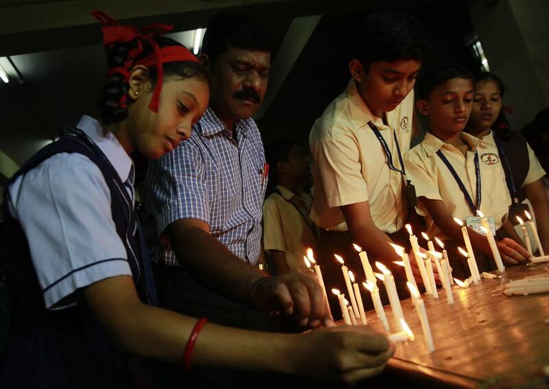 India school children and officials light candles in memory of victims killed in a Taliban attack. Rafiq Maqbool / AP Photo