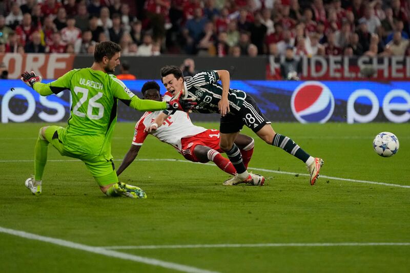 Bayern Munich's Alphonso Davies makes a goal-saving tackle against Manchester United's Facundo Pellistri. AP 