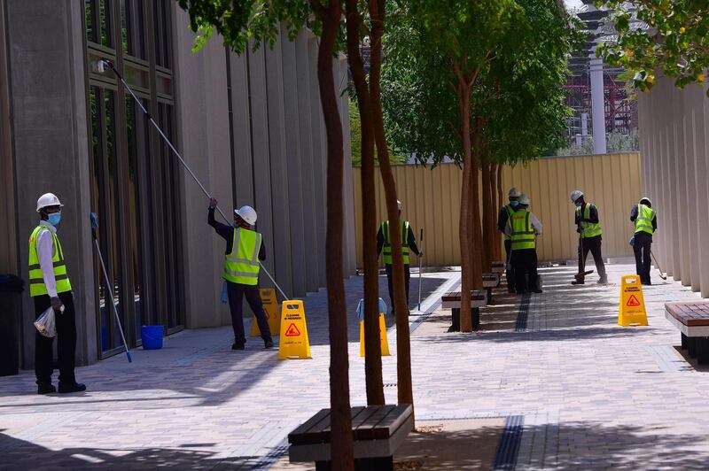 Workers cleaning up windows and pathways at the under-construction Dubai Expo 2020 site. AFP
