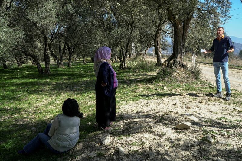 Tayyibe Demirel talks with a mining company official in her olive grove, in Turgut, Mugla province, Turkey. She has won a court case against the expansion of an open-pit coal mine towards her village. Reuters