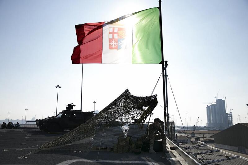 An Italian marine keeps watch on the deck of the Cavour. Silvia Razgova / The National
