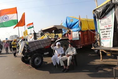 Indian farmers sit next to their tractors during a protest at the Delhi Ghazipur Border, near New Delhi. EPA