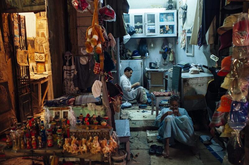 Egyptian shopkeepers sit at their shops in the tourist market in central Luxor. Postrevolutionary Egyptian governments have dithered over ending unaffordable subsidies. Ed Giles / Getty Images