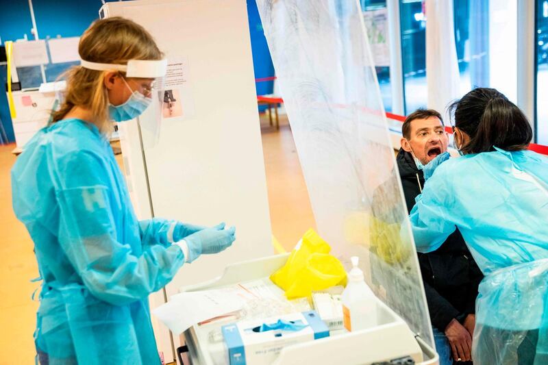 Medical staff members take a samples from a patient to test him for the novel coronavirus on May 6, Herlev Hospital, Copenhagen, Denmark. 
Ritzau Scanpix / Ólafur Steinar Gestsson / AFP