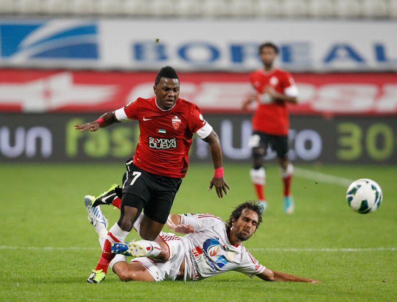 Abu Dhabi, United Arab Emirates , Jan 26 2013, Al Jazira v Al Ahli- (left) Al Ahli's #7 Ismaeel Al Hamadi is triped up by Al Jazira's Matias Delgado. Mike Young / The NationaL