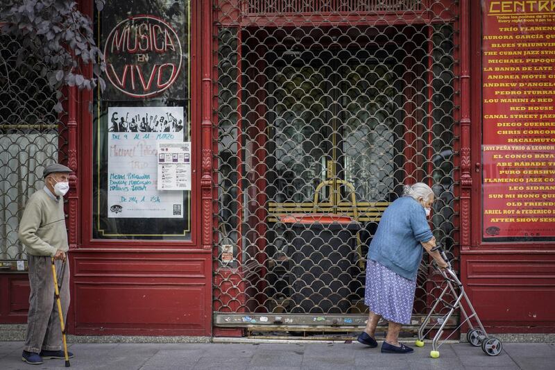 A couple walk past a closed cafe in Plaza del Angel in Madrid, Spain, on October 8. France, Spain and the Czech Republic posted record increases in coronavirus cases, underscoring growing alarm in Europe as it struggles to control the pandemic. Paul Hanna/Bloomberg