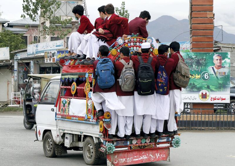 The schoolchildren ride a van as they return home in Mingora city of Pakistan‚Äôs Khyber Pakhtunkhwa province. Aamir Saeed for The National