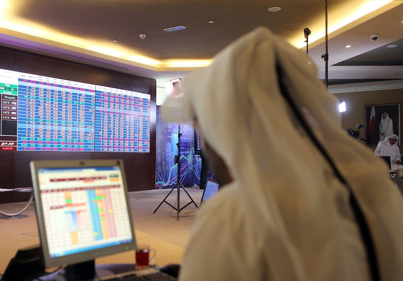 (FILES) This file photo taken on July 31, 2017 shows a Qatari trader following the stock market at the Qatari stock exchange in Doha.
Qatar's economy has been hit by the sanctions imposed by a Saudi-led Arab bloc but the emirate's economy is strong enough to survive, argue local and international analysts. / AFP PHOTO / STRINGER