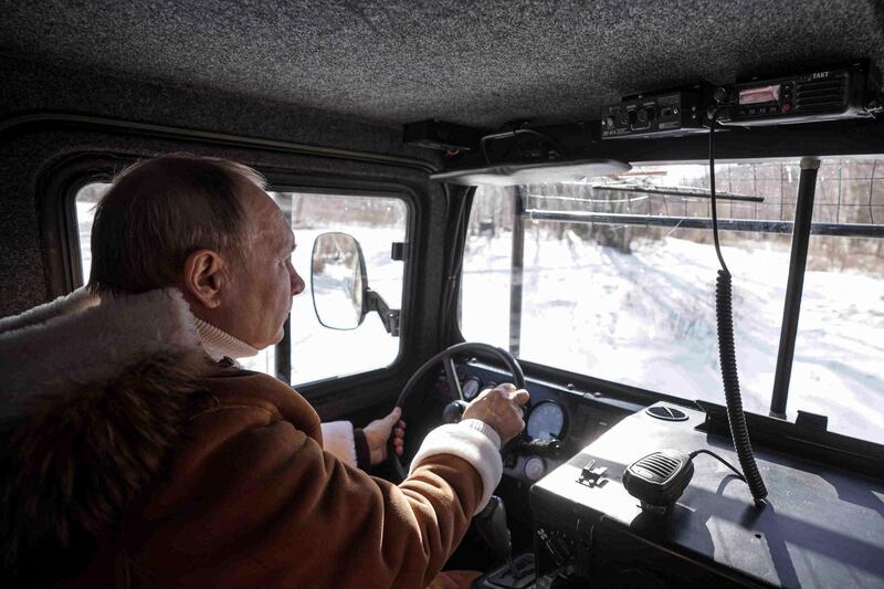 Russian President Vladimir Putin drives an all-terrain vehicle while on holiday in the Siberian taiga. AP Photo