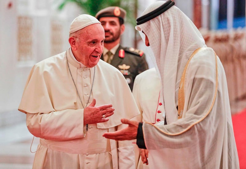 Pope Francis is welcomed by Sheikh Mohamed. AFP