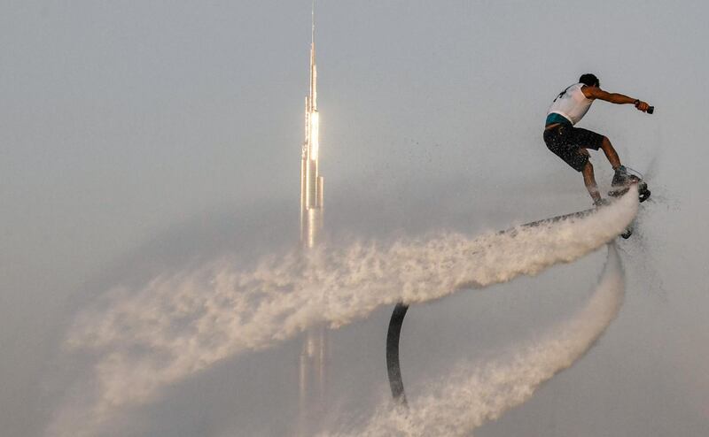 A flyboard rider performs stunts off Kite Beach near Burj Al Arab.