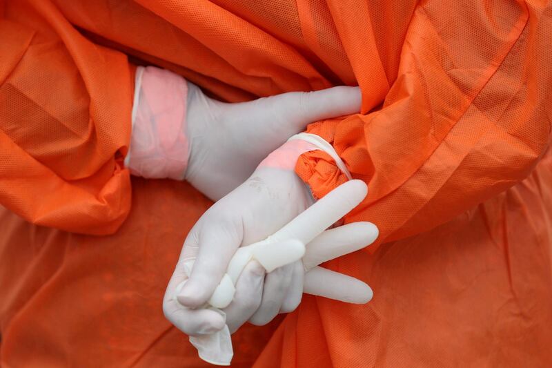 A health worker holds a glove outside the San Jose public hospital emergencies entrance in Santiago, Chile. Reuters