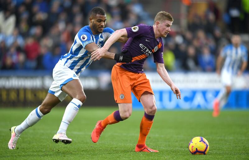 HUDDERSFIELD, ENGLAND - JANUARY 20:  Steve Mounie of Huddersfield chases down Kevin De Bruyne of Manchester City during the Premier League match between Huddersfield Town and Manchester City at John Smith's Stadium on January 20, 2019 in Huddersfield, United Kingdom. (Photo by Gareth Copley/Getty Images)