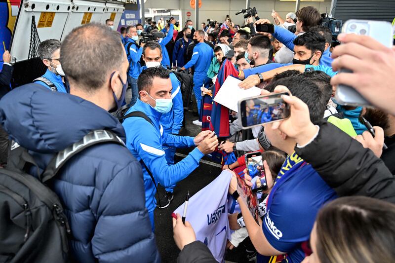 Xavi Hernandez signs autographs to fans at Sydney International Airport. AFP
