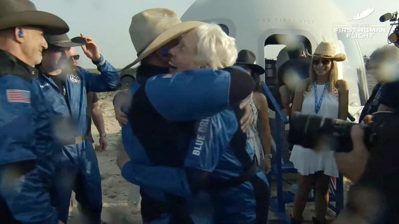 Billionaire businessman Jeff Bezos embraces veteran aviator Wally Funk after Blue Origin’s reusable New Shepard craft capsule returned from space on Tuesday, July 20, 2021.