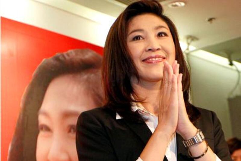 Opposition Phue Thai party's Yingluck Shinawatra gives Thai traditional "wai" greeting after a press conference at the party headquarters in Bangkok, Thailand, Sunday, July 3, 2011. The apparent election result on Sunday paved the way for Yingluck Shinawatra to become Thailand's first female prime minister. (AP Photo/Wason Wanichkorn) *** Local Caption ***  Thailand Election.JPEG-0d8e6.jpg