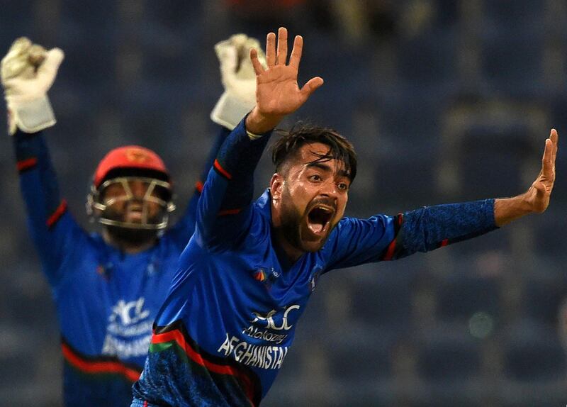 Afghan cricketer Rashid Khan (R) appeals for an unsuccessful leg before wicket (LBW) decision against unseen Bangladesh batsman Mosaddek Hossain during the one day international (ODI) Asia Cup cricket match between Bangladesh and Afghanistan at The Sheikh Zayed Stadium in Abu Dhabi on September 20, 2018. / AFP / ISHARA S.  KODIKARA
