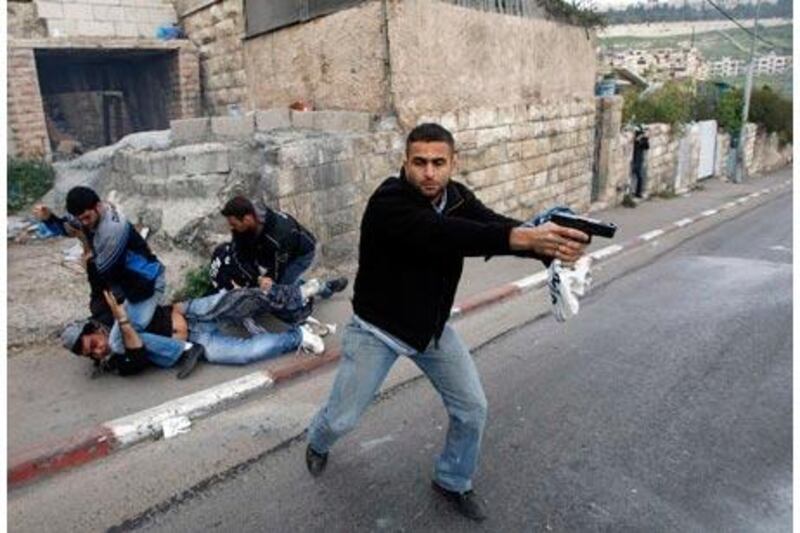 A reader expresses her dissatisfaction with the photo caption that ran with this picture on March 17. In her view, a 'suspect' is not being 'detained', but instead a Palestinian protester is being unjustly beaten.