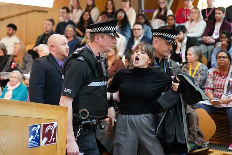 Police and security officers were forced to remove protesters from the Scottish Parliament in Edinburgh on Thursday, as Humza Yousaf led First Minister's Questions. AP