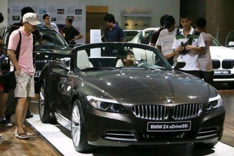 Luxury cars and expensive mobile phones are on the wish lists of young adults in the UAE. Greg Baker / AP Photo