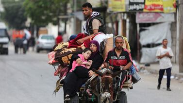 Palestinians travel in a donkey-drawn cart loaded with their belongings as they flee Rafah. Reuters