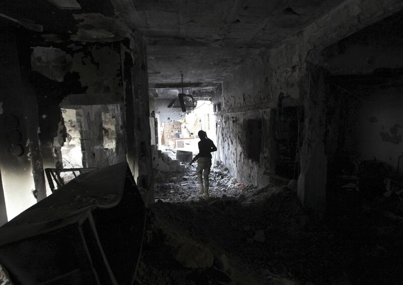 A Free Syrian Army fighter inside a damaged house in Deir Al Zor, eastern Syria. Khalil Ashawi / Reuters