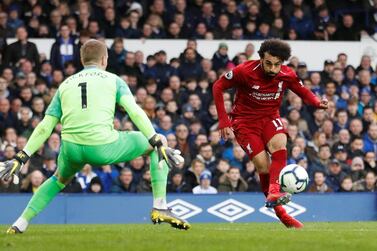 Everton goalkeeper Jordan Pickford saves a shot from Liverpool striker Mohamed Salah at Anfield. Reuters