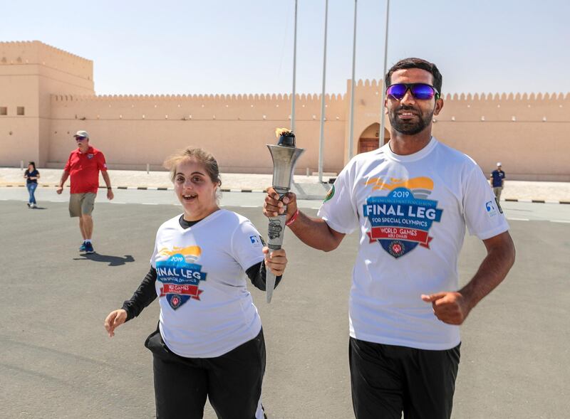 Abu Dhabi, United Arab Emirates, March 12, 2019.Special Olympics Torch Run Photo Opp at the Al Dhafrah Fort. --(L-R)  Chaica Al Qassimi and Yassir Al Zaabi during the torch run.
Victor Besa/The National
Reporter:  Shireena Al Nuwais
Section:  NA