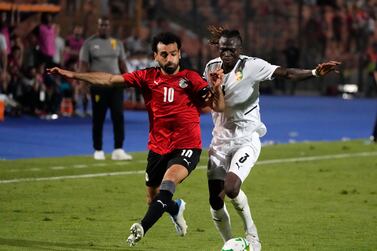 Egypt's Mohamed Salah, left, fights for the ball with Guinea's Issiaga Sylla during their soccer match in Group D 2023 Cup of Nations (AFCON) qualifiers at Cairo International stadium in Cairo, Egypt, Sunday, June 5, 2022.  Egypt won 1-0.  (AP Photo / Amr Nabil)