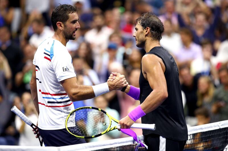 Marin Cilic of Croatia (L) shakes hands with Rafael Nadal of Spain after losing to him int heir Men's Singles fourth round match on day eight of the 2019 US Open at the USTA Billie Jean King National Tennis Center in Queens borough of New York City.  AFP