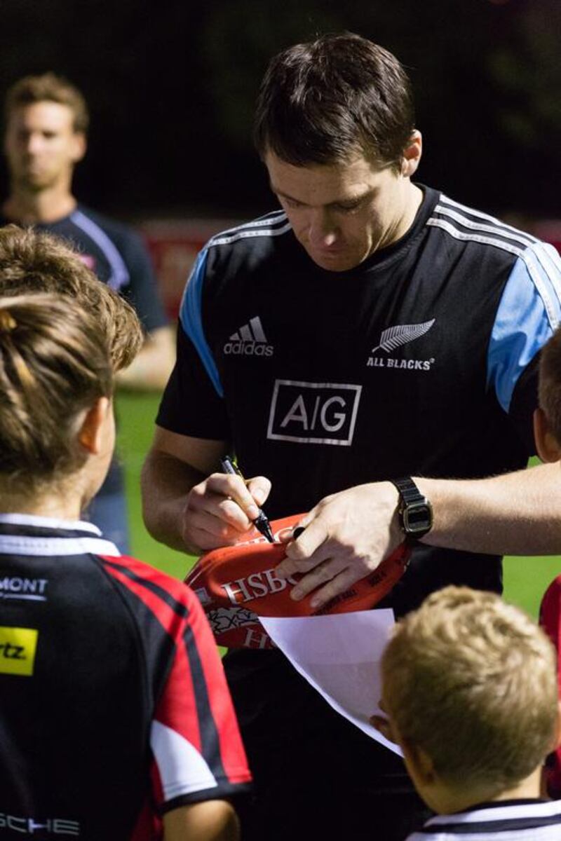 Ben Smith signs autographs for the juniors on Tuesday night. Duncan Chard for The National