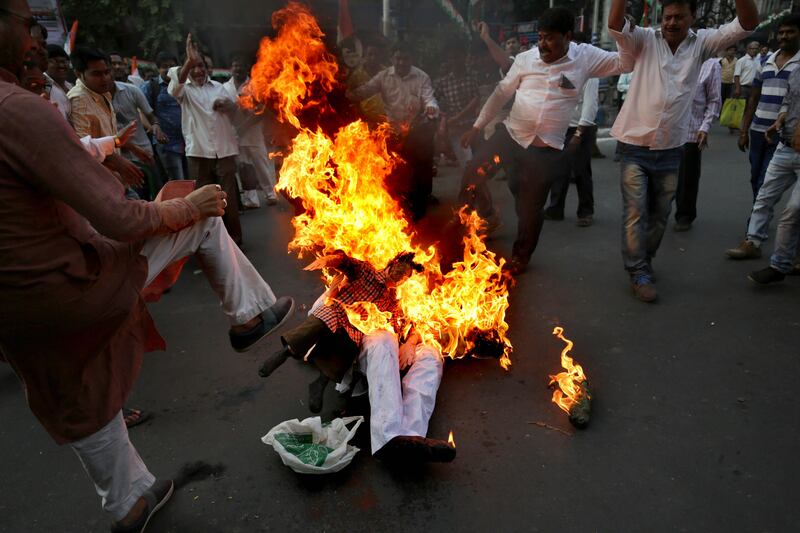 epa06315671 Indian National Congress party activists burn an effigy of Prime Minister of India Narendra Modi during a protest to mark the first anniversary of the note ban in Calcutta, eastern India, 08 November 2017. On 08 November 2016, Indian Prime Minister Narendra Modi banned Indian currency notes with denomination values of INR 500 (around 6.63 Euro) and INR 1000 (around 13.27 Euro) as a step towards curbing the problem of black money.  EPA/PIYAL ADHIKARY