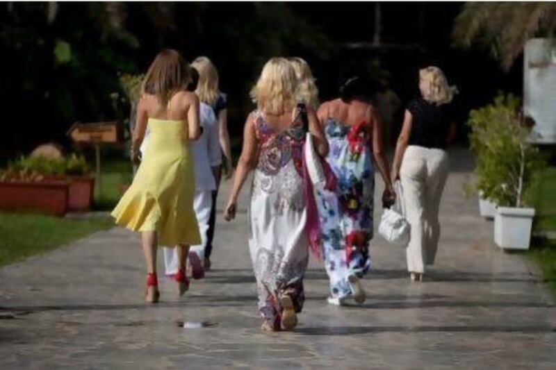 Tourists stroll through the Heritage Village in Abu Dhabi on Wednesday afternoon. Silvia Razgova / The National