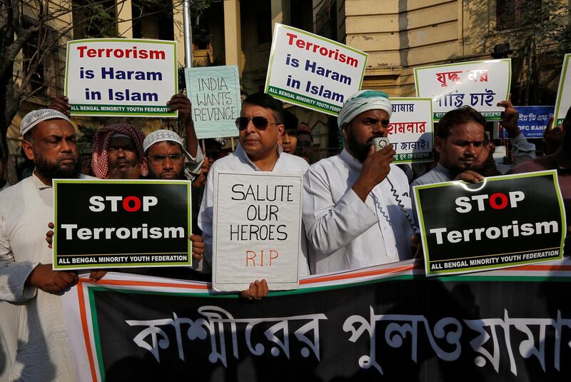Muslims hold placards during a prayer meeting to pay tribute to Central Reserve Police Force (CRPF) personnel who were killed after a suicide bomber rammed a car into the bus carrying them in south Kashmir last week, outside a mosque in Kolkata, India, February 20, 2019. REUTERS/Rupak De Chowdhuri