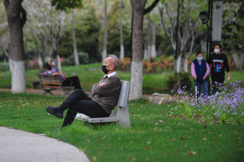 A man sits on a bench at a park in Wuhan, in China's central Hubei province on March 26, 2020. AFP