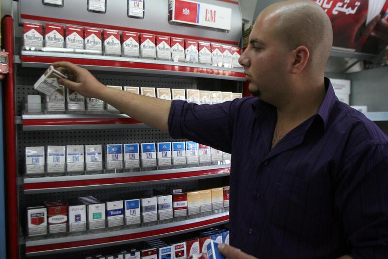 AMMAN, JORDAN: A Jordanian man works in his tobacco store in Amman, Jordan May 08, 2008. (Salah Malkawi/ The National) *** Local Caption ***  SM005_Tobacco.jpgSM005_Tobacco.jpg