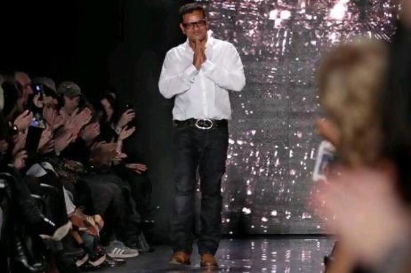 The fashion designer Naeem Khan takes a bow after his Autumn/Winter 2012 show in New York.