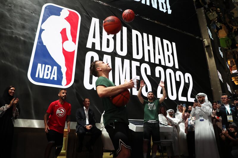 A freestyle performer juggles basketballs during the press conference for the NBA Abu Dhabi Games.